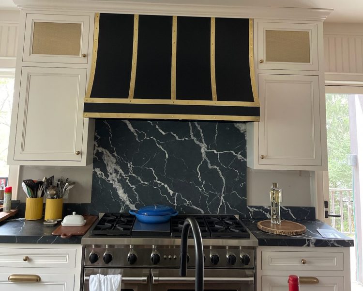 high capacity range hood above large residential cooking range.